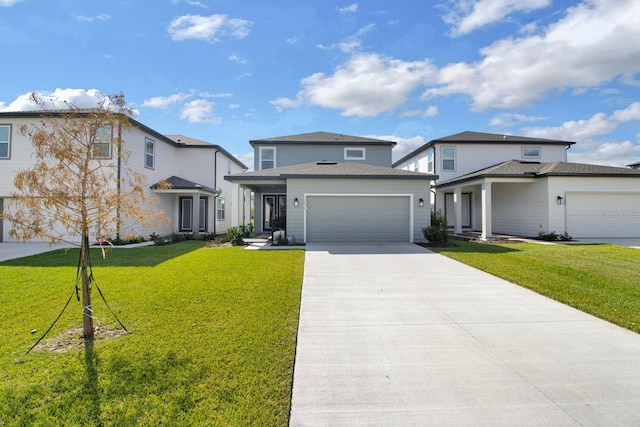 view of front of house with an attached garage, driveway, and a front yard