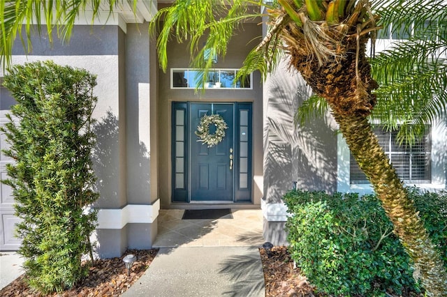 property entrance featuring stucco siding