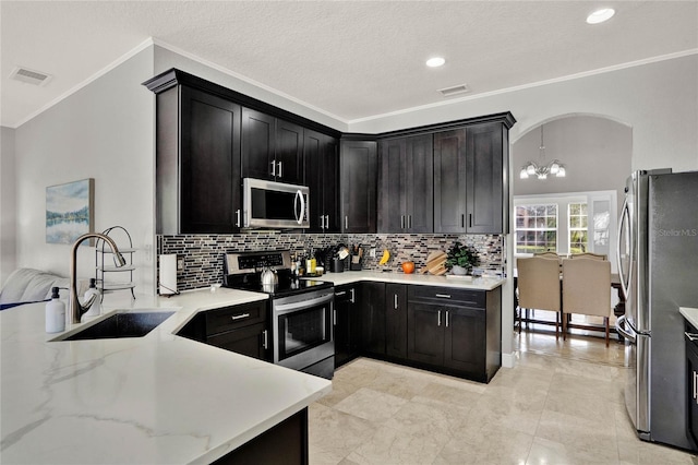 kitchen featuring stainless steel appliances, a sink, visible vents, and light stone countertops