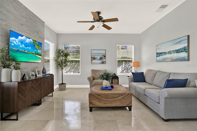 living area featuring marble finish floor, a wealth of natural light, visible vents, and baseboards