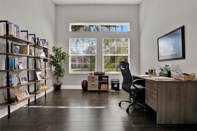 home office with dark wood finished floors and baseboards