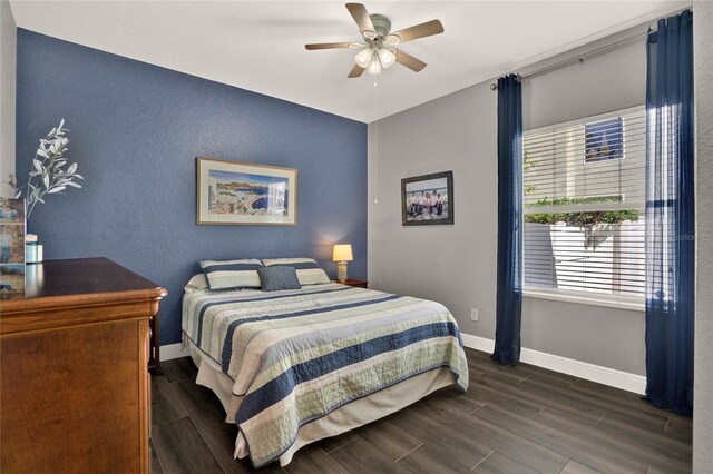 bedroom with baseboards, a ceiling fan, and wood finish floors