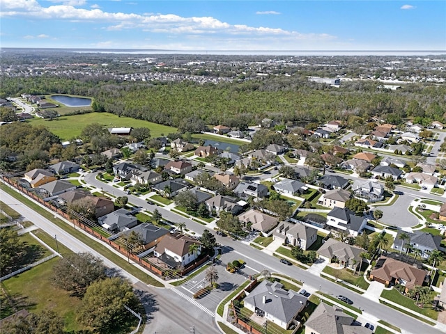 birds eye view of property with a residential view and a water view