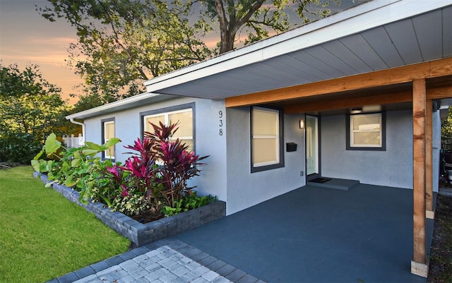 exterior space featuring a lawn and stucco siding