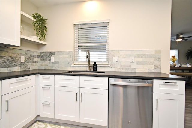 kitchen with a sink, dark countertops, open shelves, and stainless steel dishwasher