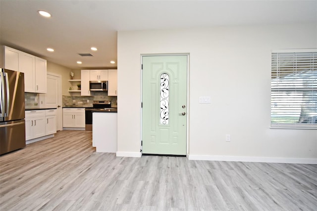 kitchen featuring open shelves, stainless steel appliances, dark countertops, tasteful backsplash, and visible vents