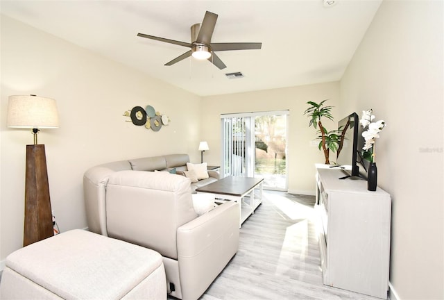 living room featuring light wood finished floors, ceiling fan, and visible vents