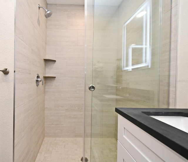 full bathroom featuring a stall shower and vanity