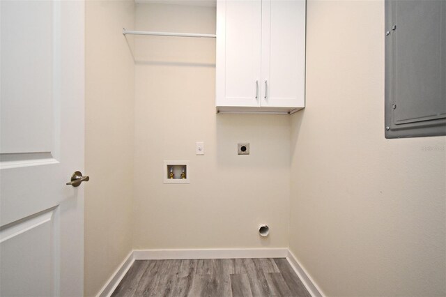 laundry room featuring hookup for an electric dryer, washer hookup, wood finished floors, electric panel, and cabinet space