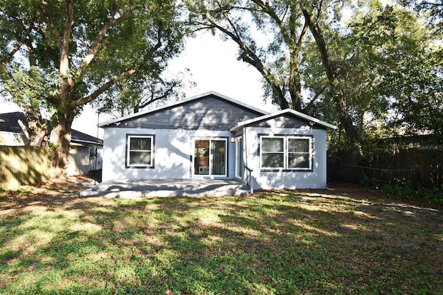 view of front of property with a front yard, fence, and a patio