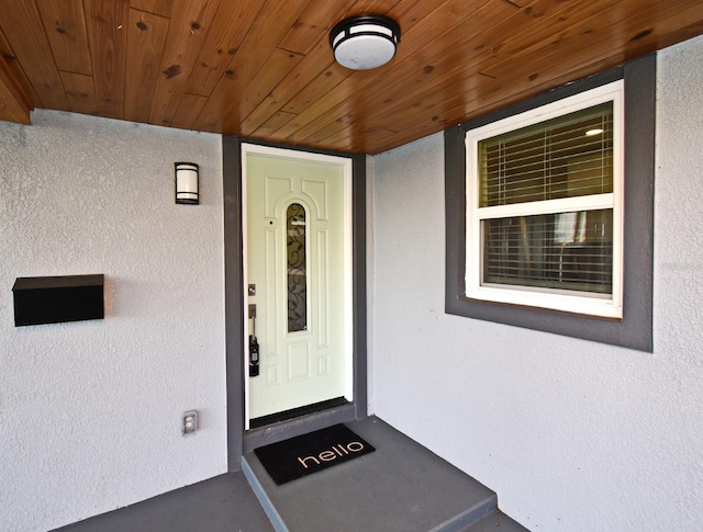 property entrance with stucco siding