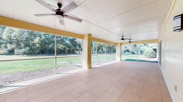 unfurnished sunroom with ceiling fan