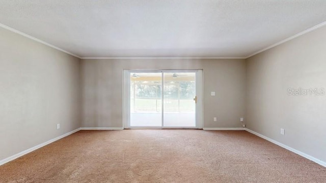 carpeted spare room with baseboards and ornamental molding