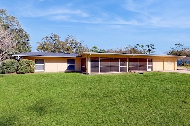 view of front facade with a garage, concrete driveway, and a sunroom