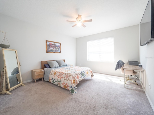 bedroom with a ceiling fan, carpet flooring, and baseboards