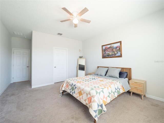 bedroom with visible vents, ceiling fan, light carpet, and baseboards