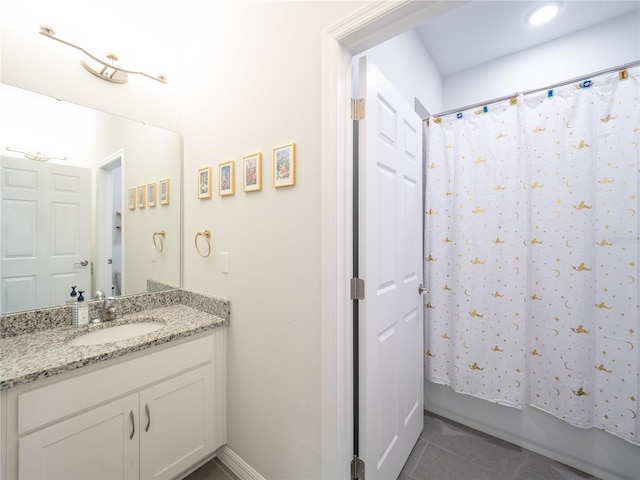 bathroom with tile patterned flooring, shower / tub combo with curtain, and vanity