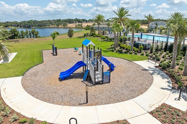 community play area featuring a water view and a yard