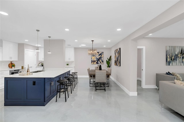 2015 Summerfield Rd, Winter Park, FL 32792 - kitchen with white cabinets, baseboards, recessed lighting, light countertops, and a chandelier
