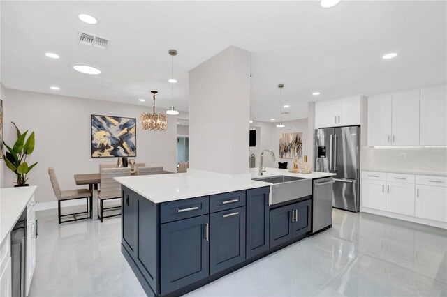 2015 Summerfield Rd, Winter Park, FL 32792 - kitchen with stainless steel appliances, a sink, white cabinets, a chandelier, and recessed lighting