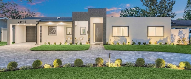 2015 Summerfield Rd, Winter Park, FL 32792 - view of front of home with stucco siding, a yard, and driveway