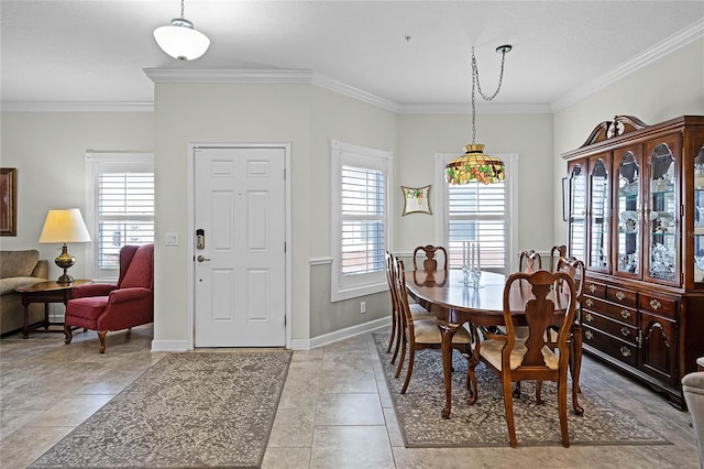 dining room featuring tile patterned flooring, crown molding, and baseboards