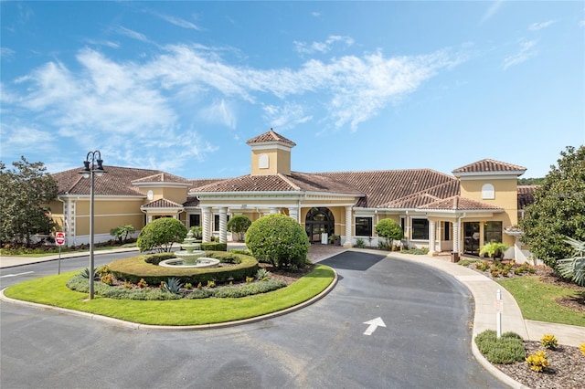 view of building exterior with curved driveway