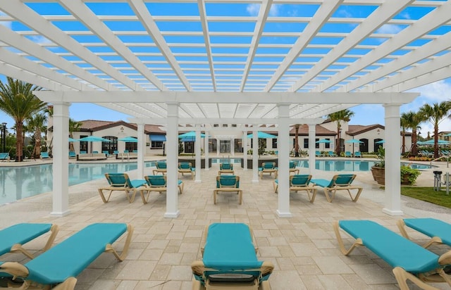 view of patio / terrace with a community pool and a pergola