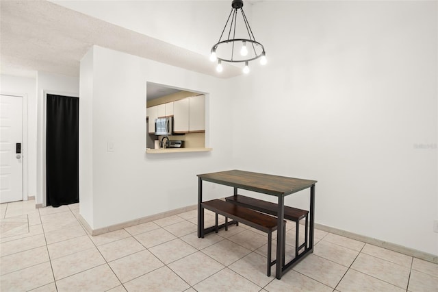 dining room featuring baseboards and light tile patterned flooring