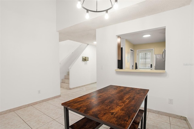 dining area with stairs, baseboards, and light tile patterned flooring