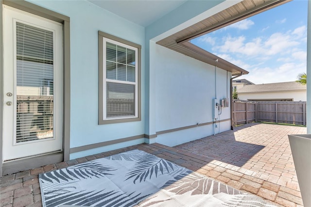 view of patio featuring fence