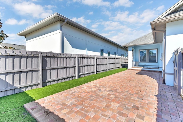 view of patio featuring fence