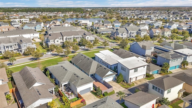 drone / aerial view featuring a water view and a residential view