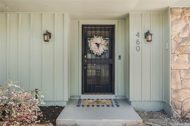 view of exterior entry featuring board and batten siding