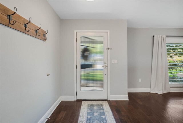 entryway featuring baseboards and wood finished floors