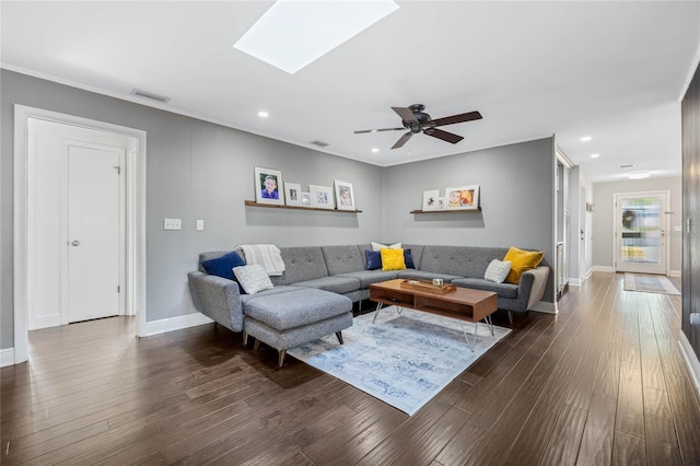 living room featuring a ceiling fan, visible vents, a skylight, recessed lighting, and dark wood-type flooring