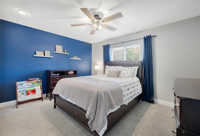 carpeted bedroom featuring baseboards and a ceiling fan