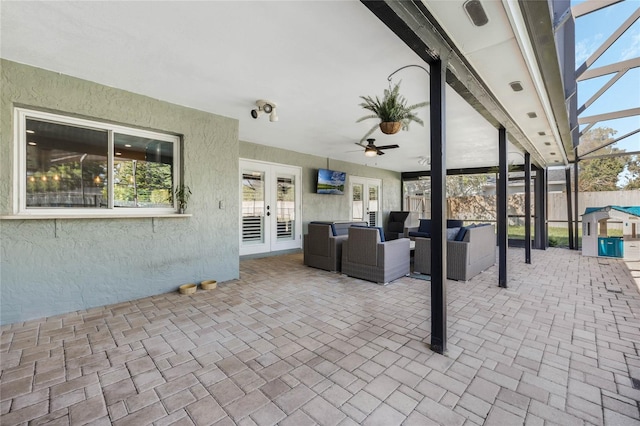 view of patio with an outdoor living space, french doors, a lanai, and fence