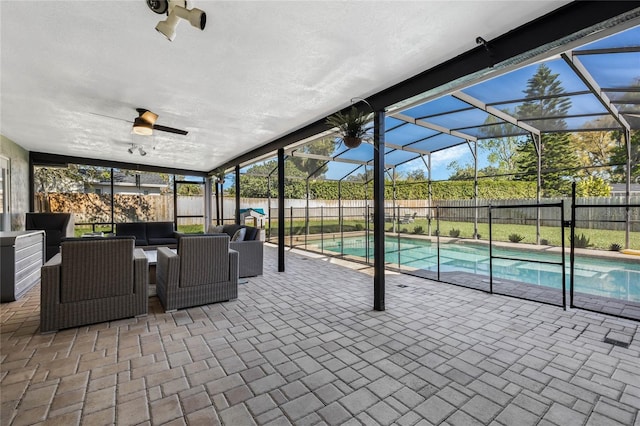 exterior space featuring a lanai, an outdoor living space, a fenced in pool, and a fenced backyard