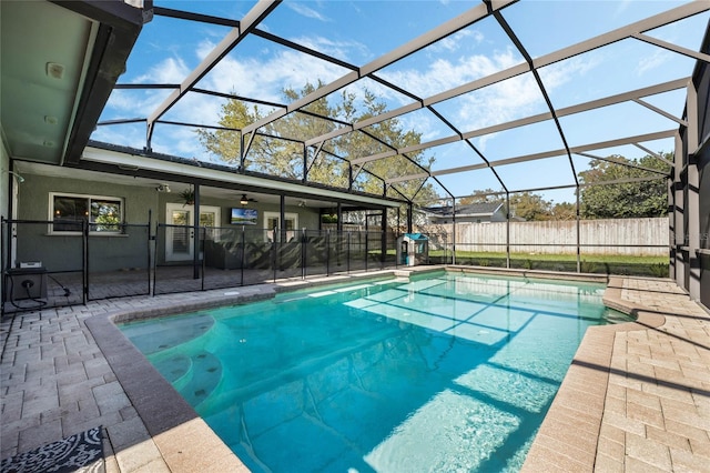 view of swimming pool with a fenced in pool, ceiling fan, a lanai, a fenced backyard, and a patio area