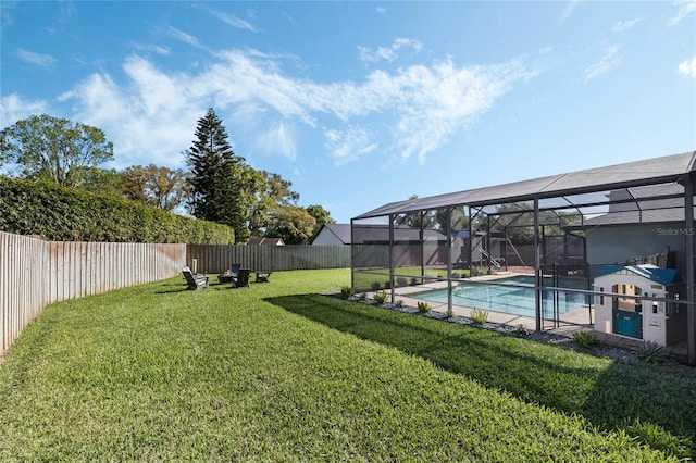 view of yard featuring glass enclosure, a fenced backyard, and a fenced in pool