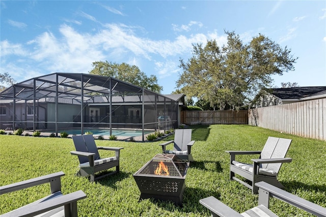 view of yard with glass enclosure, a fenced backyard, a fenced in pool, and an outdoor fire pit