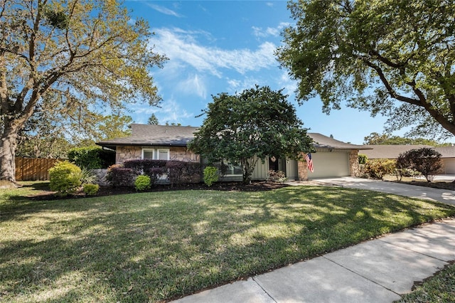 ranch-style home with driveway, a front yard, a garage, and fence