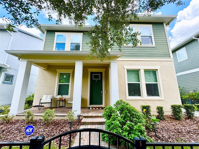 view of front of home featuring covered porch and stucco siding