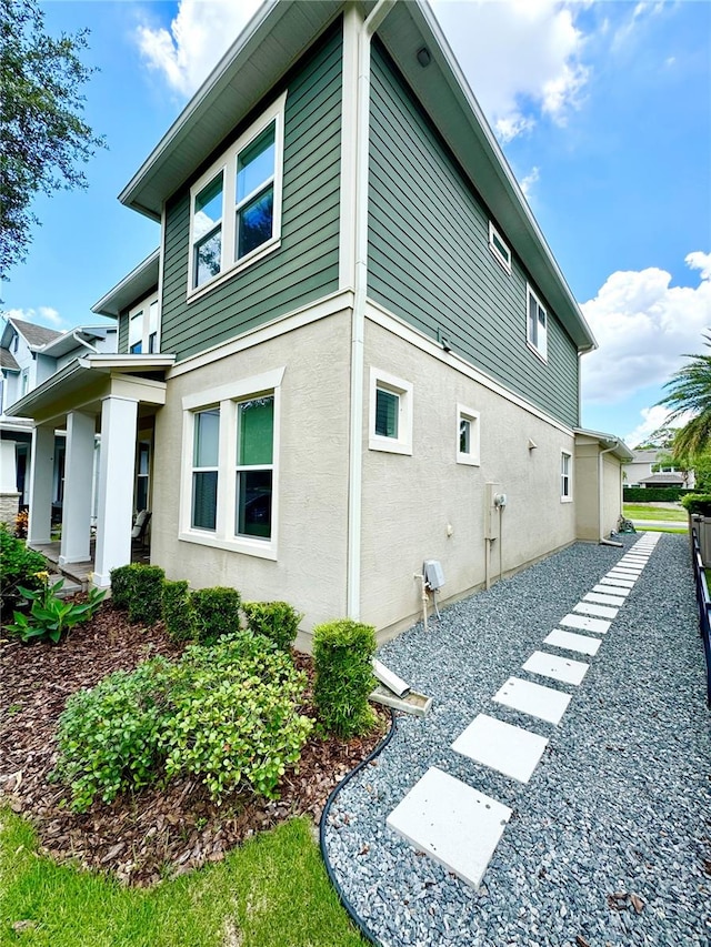 view of side of home with stucco siding