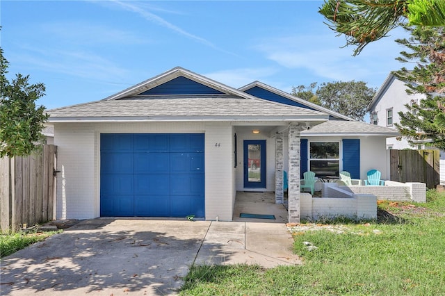 ranch-style house with an attached garage, a shingled roof, brick siding, fence, and driveway