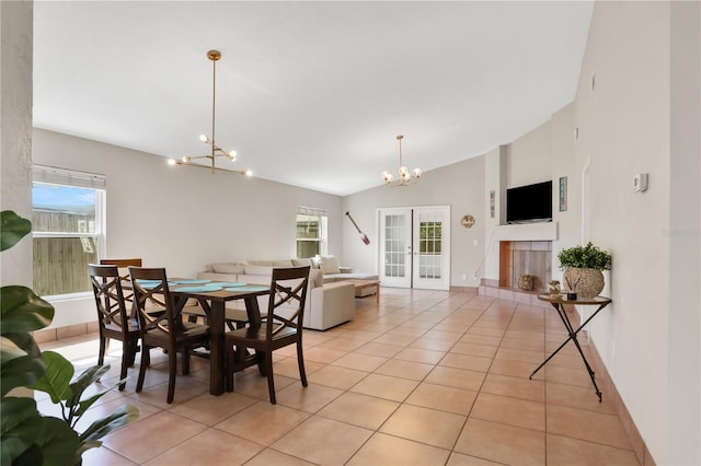 44 Capistrano Dr, Ormond Beach, FL 32176 - dining space featuring an inviting chandelier, plenty of natural light, light tile patterned floors, and french doors