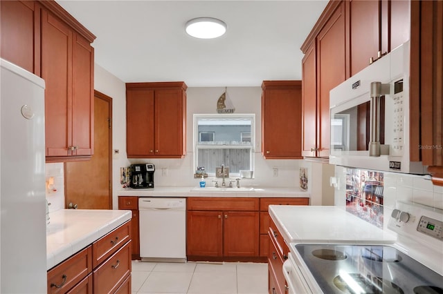44 Capistrano Dr, Ormond Beach, FL 32176 - kitchen featuring tile countertops, white appliances, a sink, tasteful backsplash, and brown cabinetry