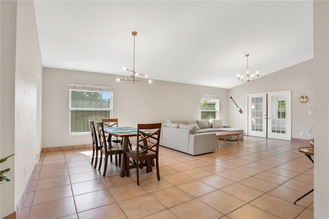 44 Capistrano Dr, Ormond Beach, FL 32176 - dining room with french doors, light tile patterned floors, lofted ceiling, an inviting chandelier, and baseboards