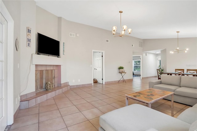 44 Capistrano Dr, Ormond Beach, FL 32176 - living area featuring light tile patterned floors, a tiled fireplace, visible vents, and a notable chandelier